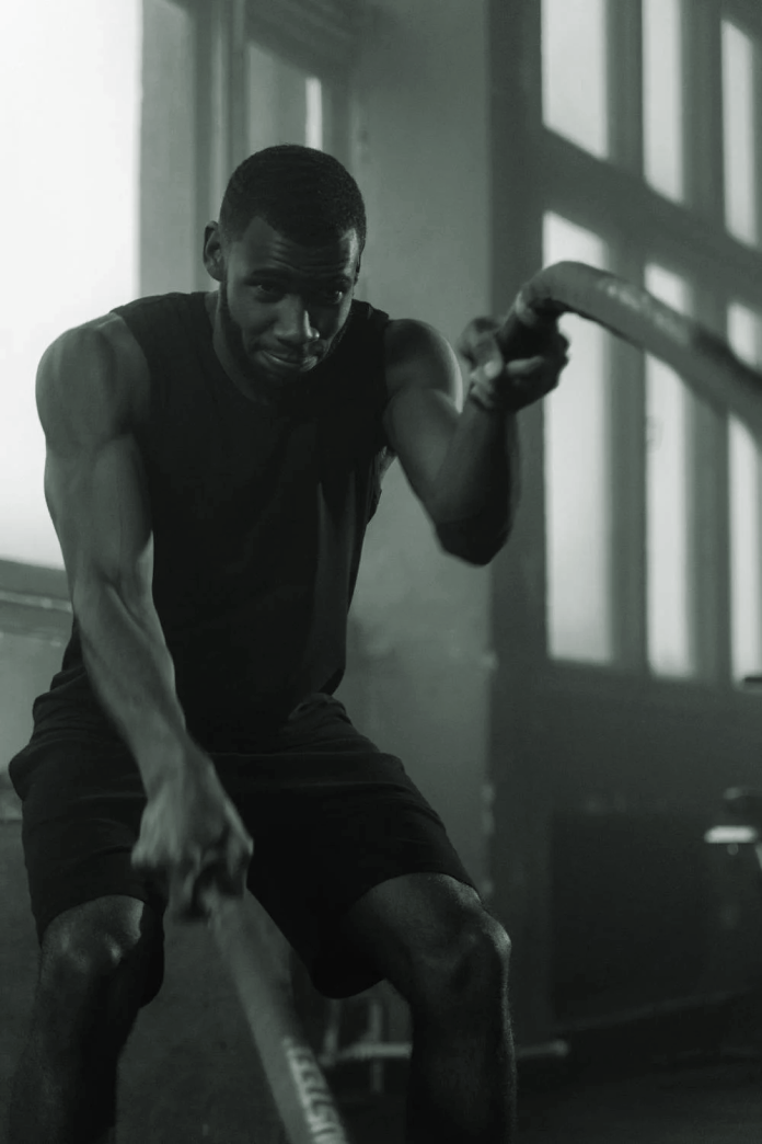 man exercising with ropes