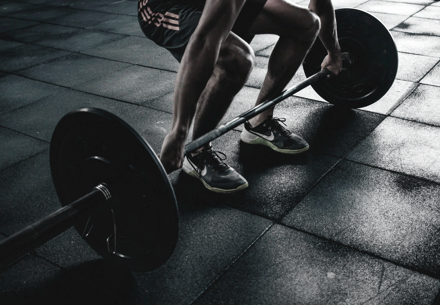 man lifting a bar bell